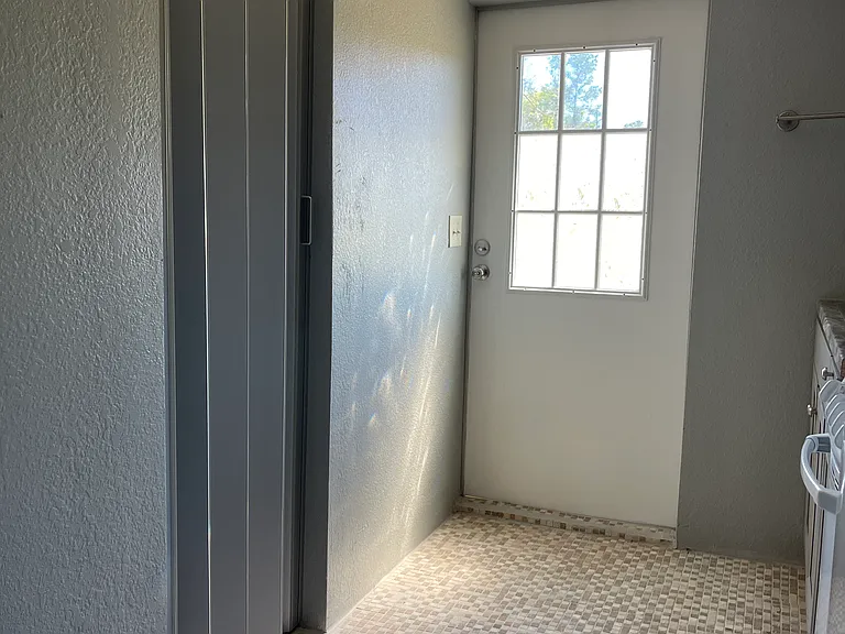 Hallway to door that leads to car parking.