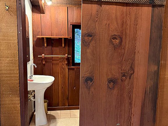Old-growth redwood barn door to the bathroom