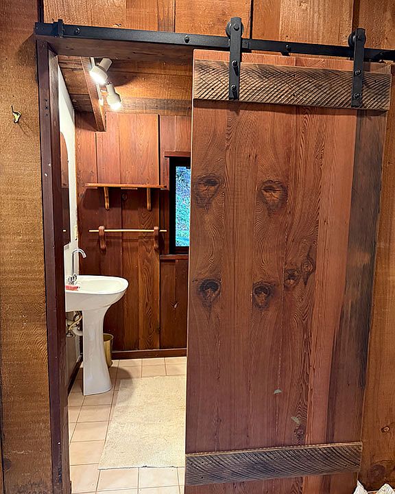 Old-growth redwood barn door to the bathroom