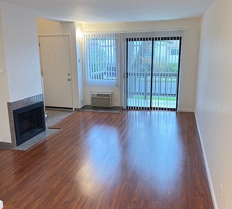 Living room with balcony and gas fireplace. Connects to breakfast nook.