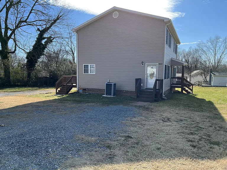 Unit B main entrance on the front of the building (with small covered porch). There is now a sidewalk from the driveway to the front door.