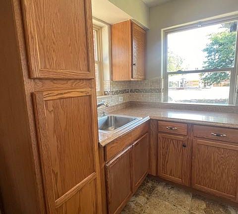 Kitchen with Pantry, pull-down faucet. All cabinets are clean and have fresh shelf liners.