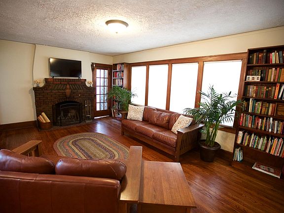 Terrific living room with four panel windows, built in bookc