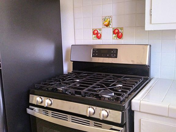 Kitchen with new appliances and original tile