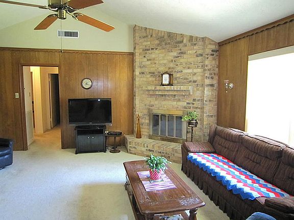 Corner wood burning fireplace & wall size window.
