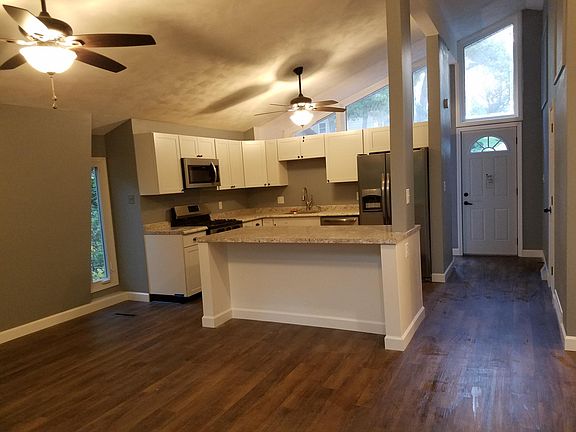 Entryway and renovated kitchen with large island and gas sto