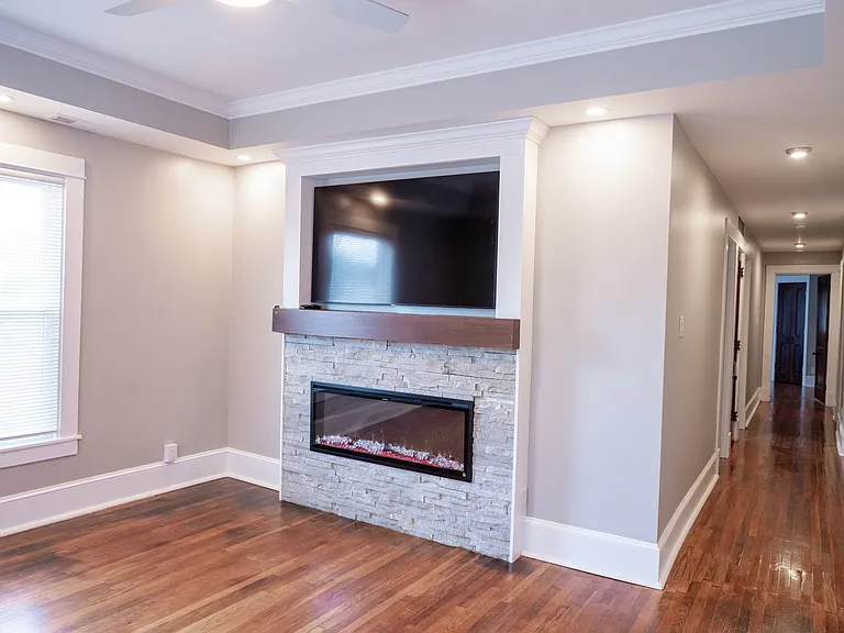 Living room with electric fireplace and TV