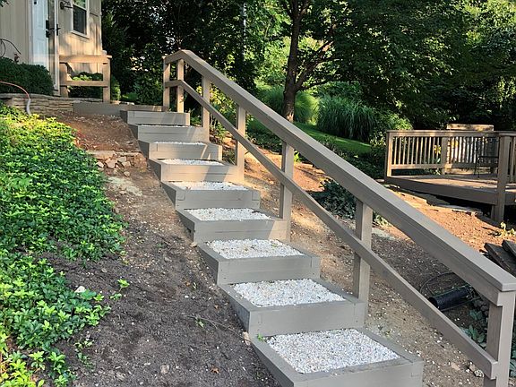 View from two parking places off street to front door of apartment