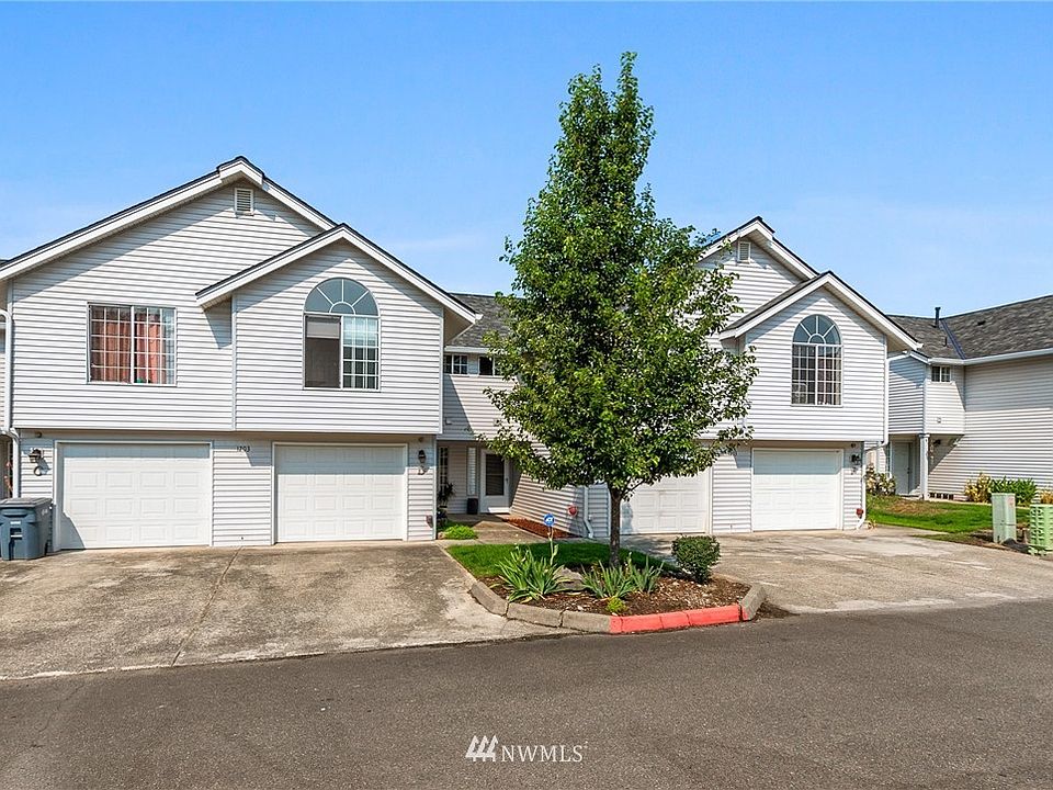 Unit to the right arched window......well cared for complex and home, flat drive way with one car garage