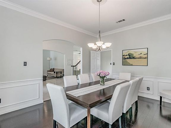 formal dinning room leads to the kitchen on the right and front entry way on the left.