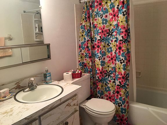 bathroom with bathtub, towels and closet