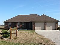Brick front exterior with permanent siding on remainder