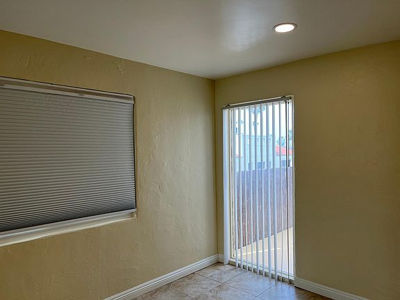 Primary bedroom with window facing patio