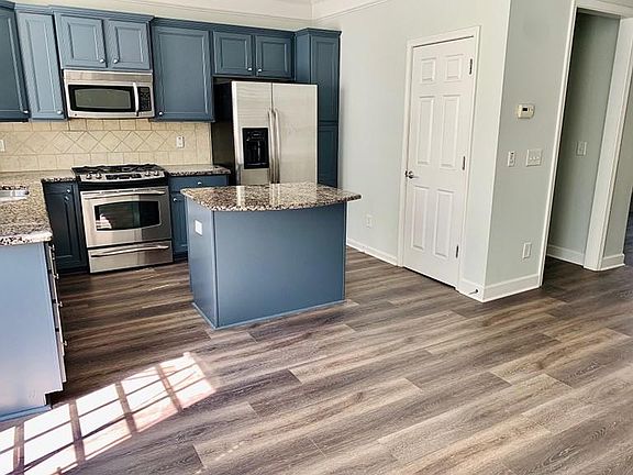 Stainless appliances and adjacent pantry space
