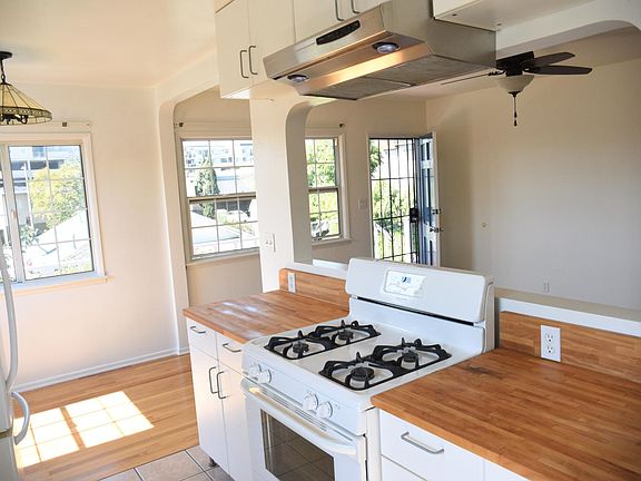 Kitchen, looking toward the front door. Dining area on the left, living room on the right.
