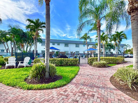 Enjoy a scenic stroll through lush tropical landscaping leading to the serene pool area.