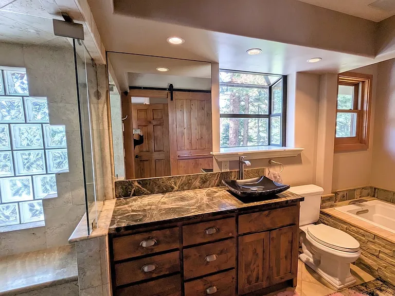 Primary ensuite bathroom includes tub, steam sauna, and shower