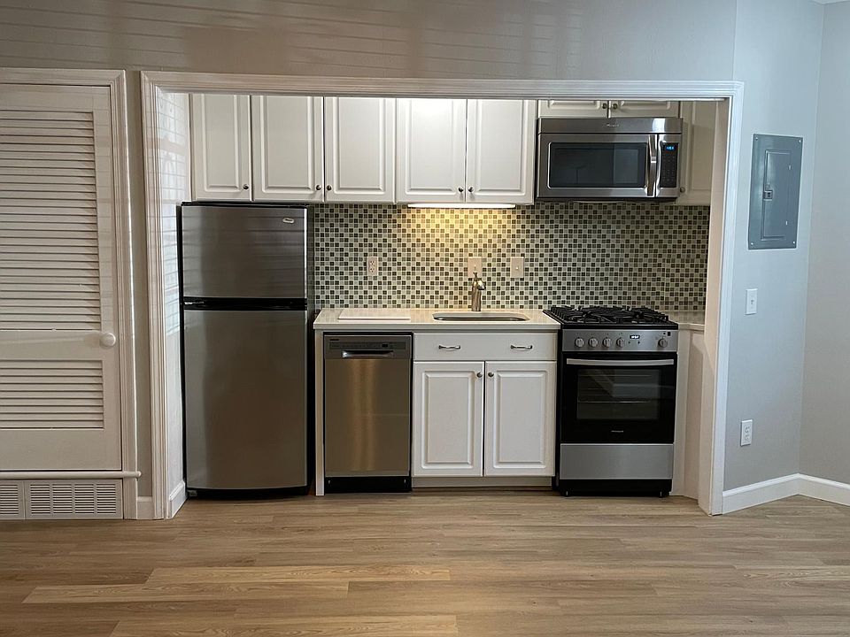 Kitchen with stainless steel appliances and quartz countertops