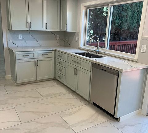 New kitchen sink and dishwasher with window facing backyard