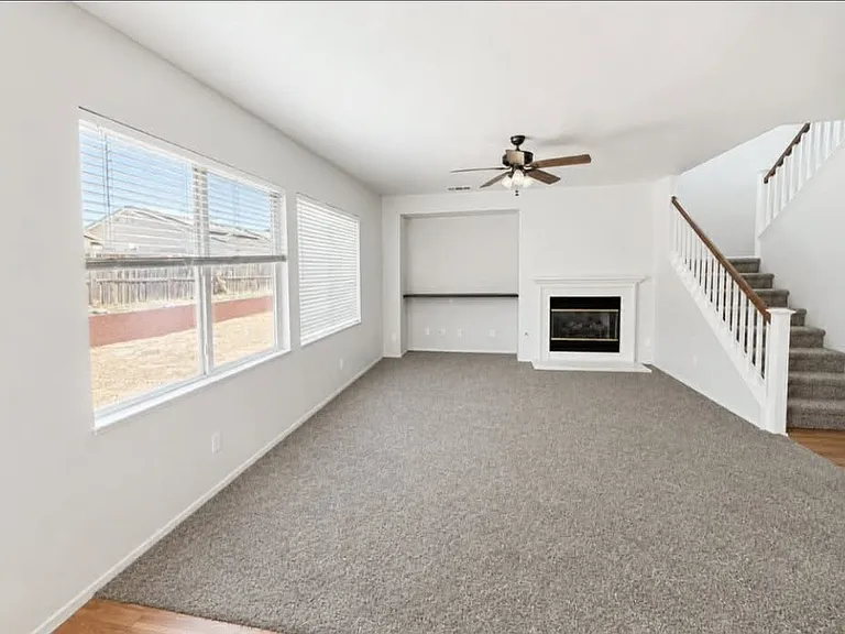 Cozy second living room located just off the kitchen, featuring a cozy fireplace.