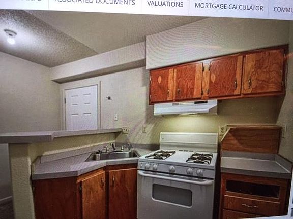 Kitchen area with refrigerator