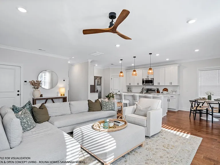 OPEN CONCEPT LIVING PICTURE FROM A DIFFERENT SAVANNAH MODEL RECENTLY BUILT BY ROLINA HOMES