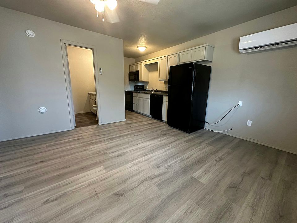 Living room, kitchen, and bathroom. View from the front door. Fresh paint.