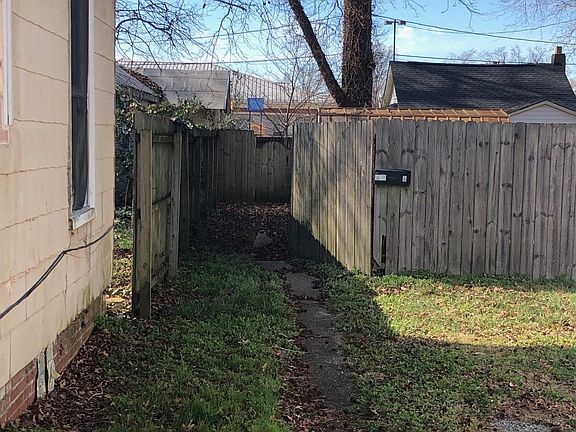 Path showing mailbox on the fence.