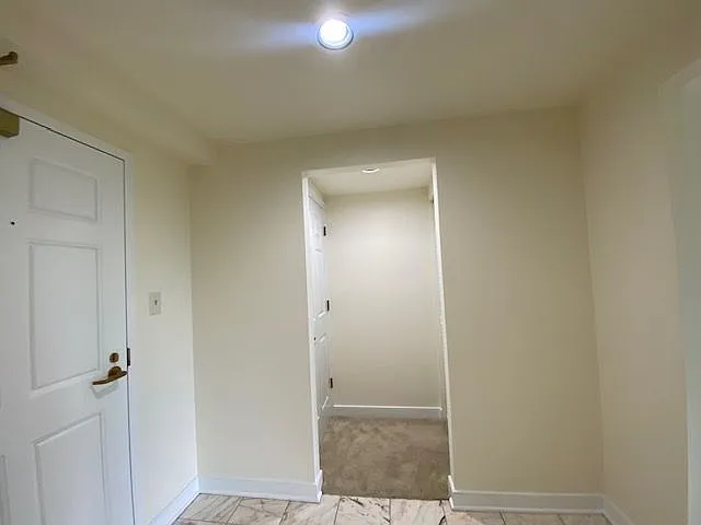 Entry hall with marble and a hall closet plus laundry room/utility room.