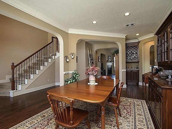 Formal Dining Room With 2 Toned Paint To Set Off All Of The Molding Such As The Chair Railing & Crown Molding.  Butler Pantry Just Steps From Formal Dining Room.