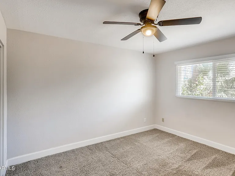 Bedroom 2 is a spacious carpeted room featuring a large closet & great views of the large corner lot front yard.