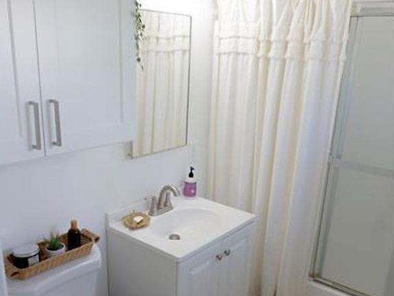 Bathroom w/new toilet and vanities (staged)