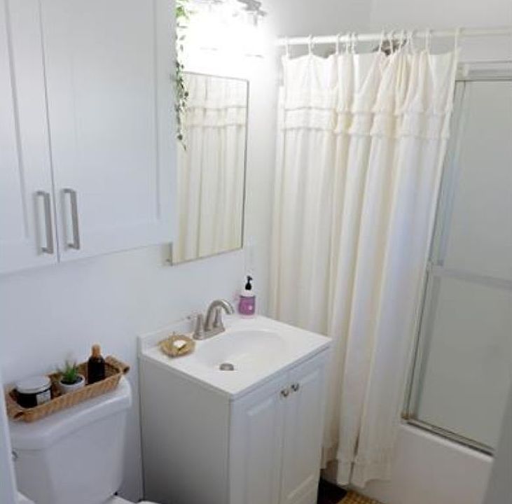 Bathroom w/new toilet and vanities (staged)