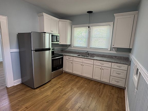 Stainless steel refrigerator, stove and microwave.