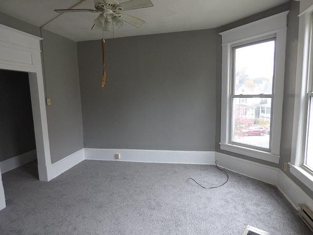 huge living room with high ceiling and ceiling fan