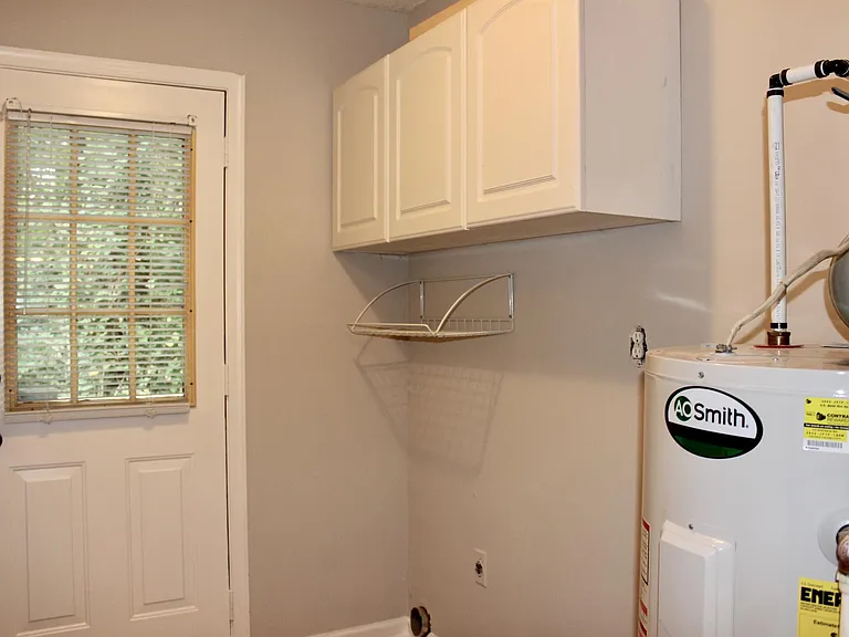 Utility Room/Laundry Room on First Floor with Access to Deck
