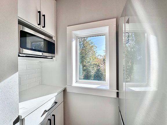 The kitchen features SS appliances, quartz countertops, premium finishes, and a window for bright natural light. Call or text for a tour today!