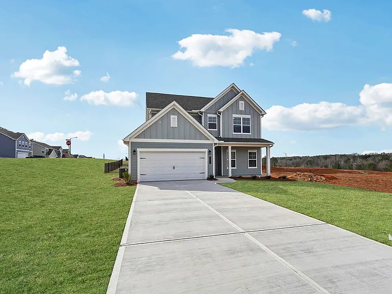 Elegant exterior of the two-story Alexander featuring a private driveway and attached garage.