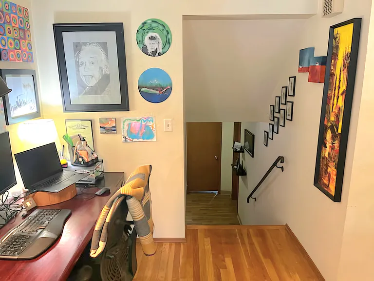 Stairwell (about 5 steps) leading to 2 bedrooms, 1 bathroom, spacious laundry/storage room, and garage access