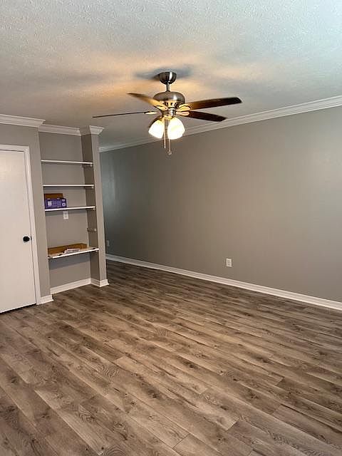Living room leading into dining and kitchen, rear patio area