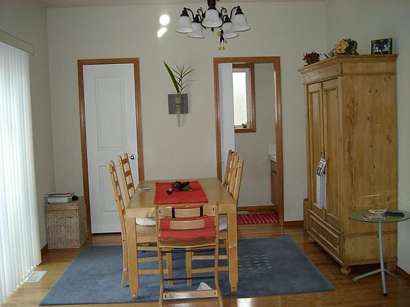 Casual dining room off kitchen, with sliding doors to patio and back yard, pantry and half-bath. (Blinds over sliding door have been removed as seen in previous kitchen photo.)