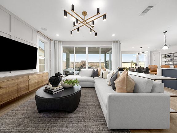 Gathering room with access to covered patio and backyard