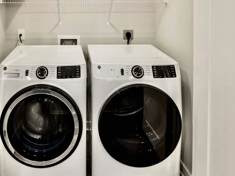 In-Unit Side-by-Side Washer and Dryer with Wire Shelf Above
