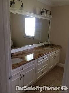 Bathroom : Double sink, granite countertop, full mirror with up to date lighting.