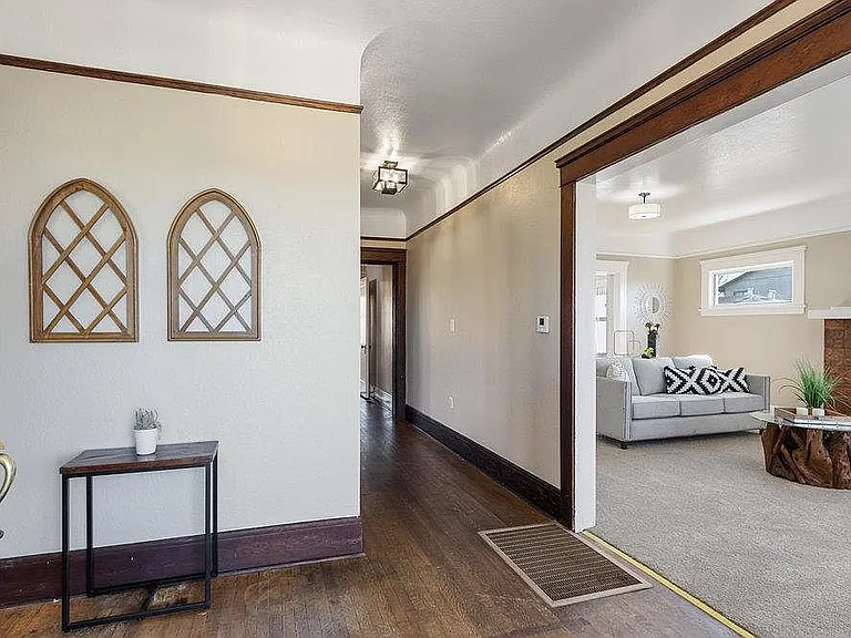Front entrance- the floors are all hardwood and flow together seamlessly- the trim has been painted white and the walls are a warm white.