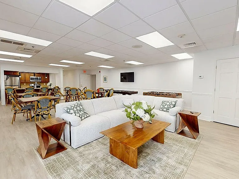 Elegant and spacious communal area with modern kitchen, inviting seating, and stylish decor, perfect for gatherings.