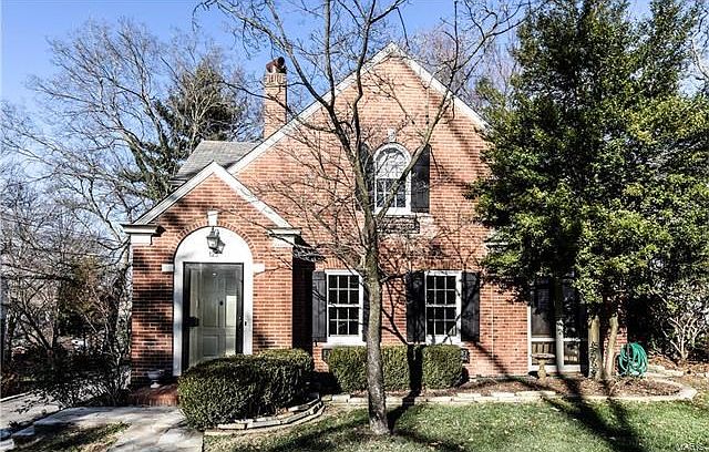 Full brick home with slate roof. Charming stone walk and enclosed entry. See screened in porch to the right. New exterior paint