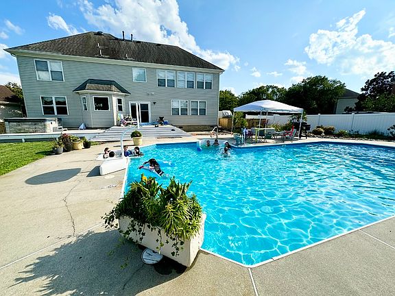 Backyard. This concrete pool deck surrounds the pool and is ready for all your entertaining needs.