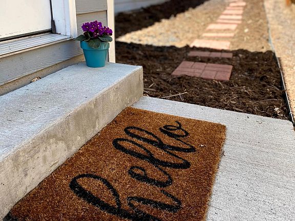 Welcome! Fenced yard with landscaping and a grill.