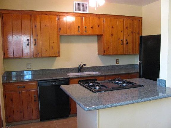Vintage knotty pine cabinets and granite countertops.